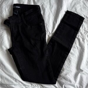 Fashion Nova Jet Black Skinny Jeans distressed back